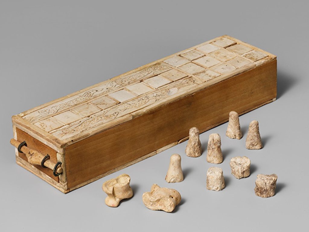 Aseb game box with playing pieces and knucklebones dice. 1635–1458 BCE. Egypt, Thebes. Ivory, copper alloy, modern wood. The Metropolitan Museum of Art, New York- 16.10.475a-k