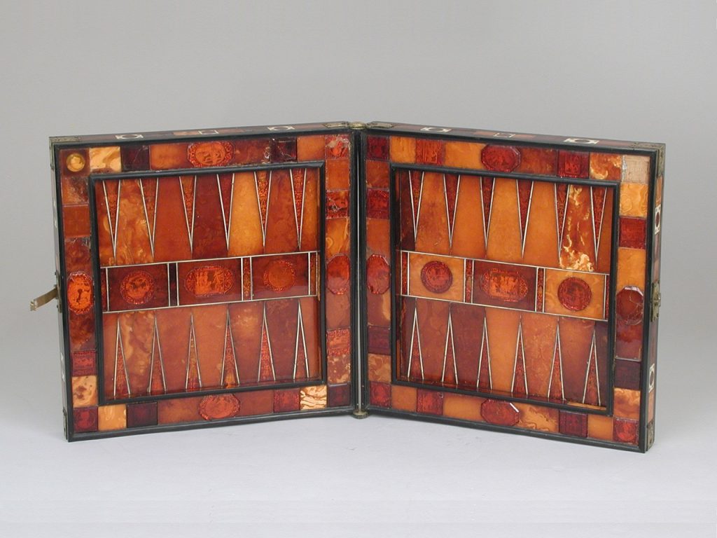 German backgammon board from the 17th century, made from amber, ivory, brass, and ebony. Metropolitan Museum of Art, 48.174.41.
